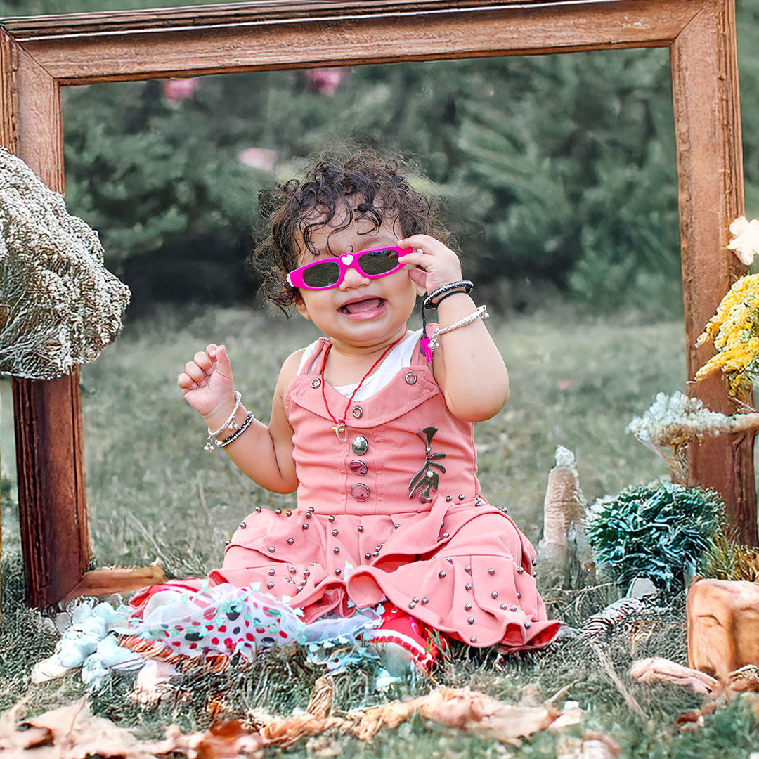 Toddler photoshoot in Ranchi with wooden frame and flowers